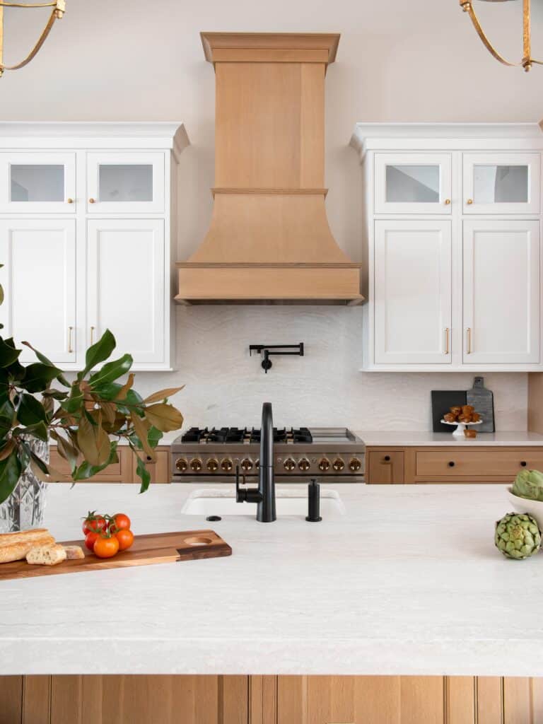 What Is Your Southside Virginia Home Worth? | Tonya Bredamus, REALTOR® Bright updated kitchen with white glass-front cabinetry, natural wood range hood, and stone-topped island in a Martinsville, Virginia home